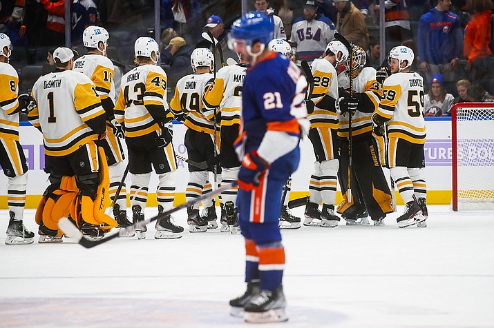 Pittsburgh Penguins' players celebrates after defeating the New York Islanders during an NHL hockey game, Friday, Nov. 26, 2021, in Elmont, N.Y. Upcoming New York Islanders games Sunday at the Rangers and Tuesday at the Philadelphia Flyers were postponed after additional members of the team went into the NHL's COVID-19 protocol on Saturday. (Eduardo Munoz Alvarez/AP)