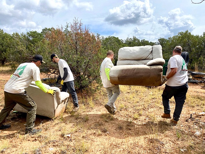 Workers with Natural Restorations remove dumped furniture and other trash from Kaibab National Forest near Ash Fork in September. (Photo/Natural Restorations)