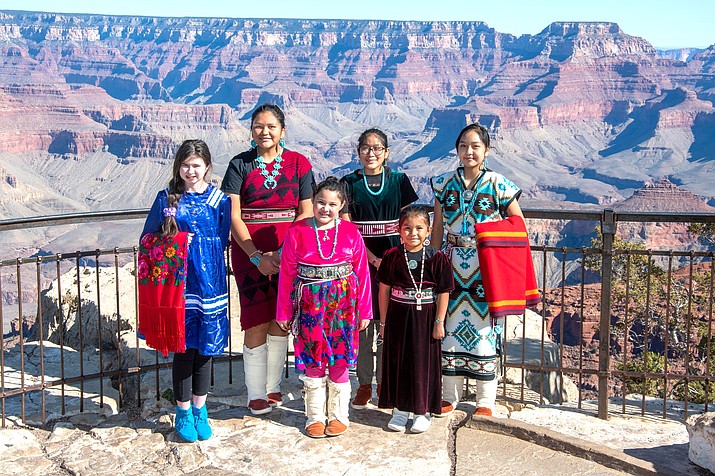 Indigenous women in traditional clothes pose on the South Rim. (NPS Photo/M. Quinn)
