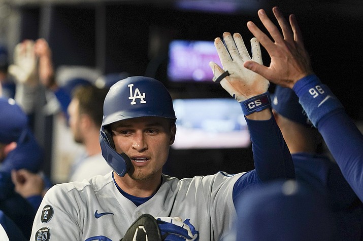 Los Angeles Dodgers’ Corey Seager is congratulated in the dugout after hitting a two-run home run against the Atlanta Braves during the first inning in Game 2 of the National League Championship Series Sunday, Oct. 17, 2021, in Atlanta. (Brynn Anderson/AP)
