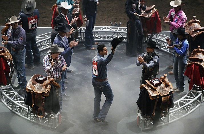 All-around champion Junior Nogueira tips his hat to the crowd during the final night of the National Finals Rodeo, Dec. 10, 2016, in Las Vegas. The 2021 event takes place Dec. 2-11 at the Thomas & Mack Center in Las Vegas. (AP Photo/John Locher)