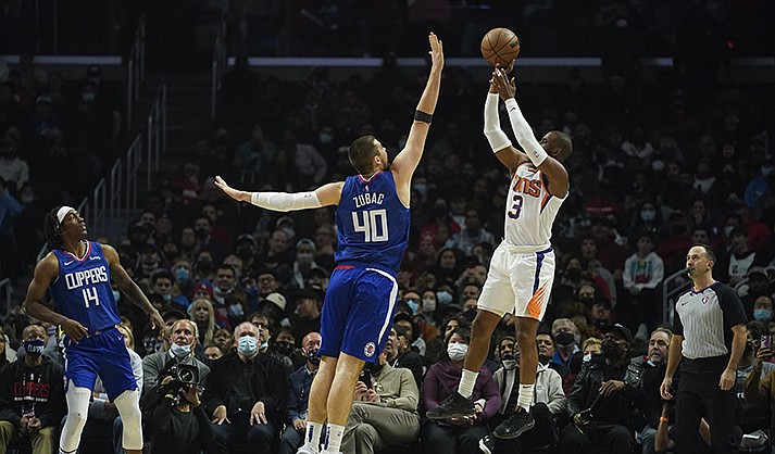 Phoenix Suns guard Chris Paul (3) shoots against Los Angeles Clippers center Ivica Zubac (40) during the first half of an NBA basketball game in Los Angeles, Monday, Dec. 13, 2021. (AP Photo/Ashley Landis)