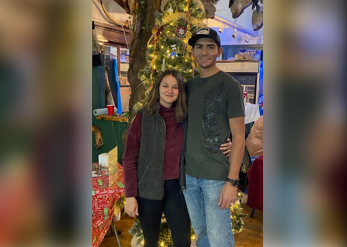 Zack and Sara Perkins of Williams stand next to a Christmas tree they won during an auction to support Save-Meant-to-Rescue. Save-MTR helps local animals in need. (Submitted photo)