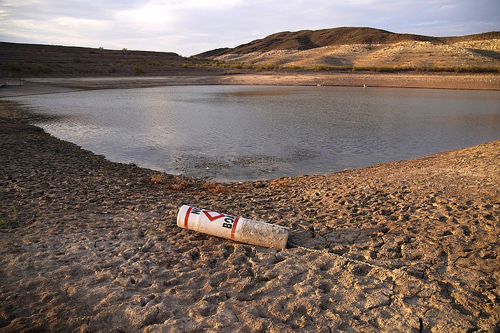 A buoy rests on the ground at a closed boat ramp on Lake Mead at the Lake Mead National Recreation Area near Boulder City, Nevada, on Aug. 13, 2021. To help stave off another round of mandatory cutbacks, water leaders for Arizona, Nevada and California are preparing to sign an agreement Dec. 15, that would voluntarily reduce water to the lower Colorado River basin states by 500,000 acre-feet for both 2022 and 2023. (AP Photo/John Locher, File)