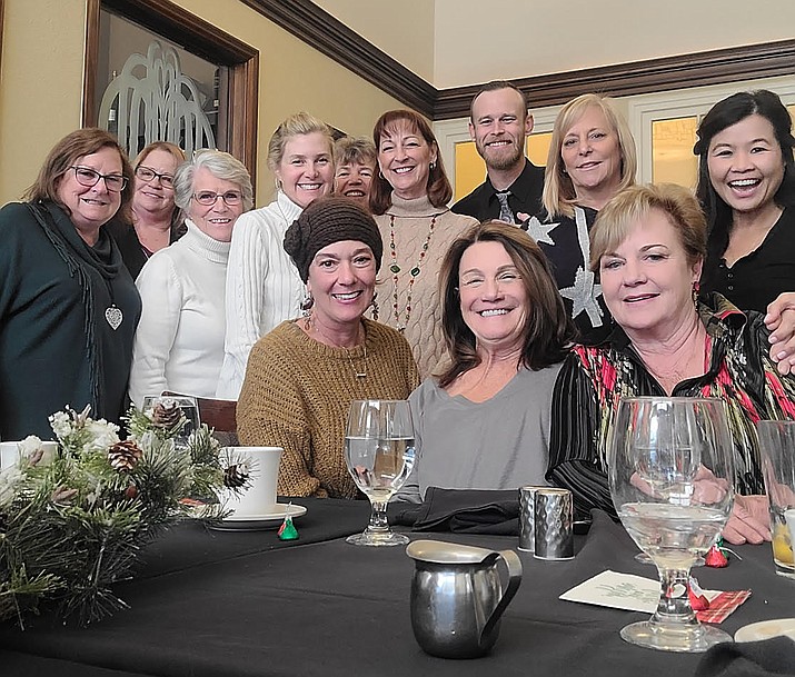 The ladies of the Blessing Brunch pose with their waiter Monday, Dec. 13, 2021, at the Hassayampa Inn in Prescott. (Courtesy)