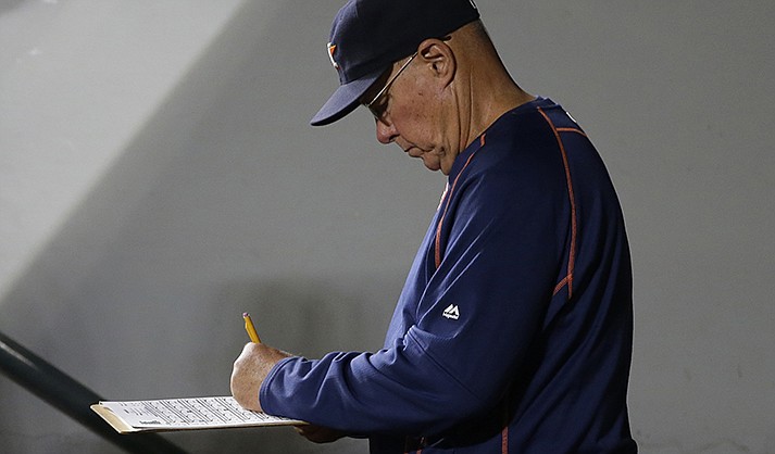 Brent Strom stands in the dugout during a baseball game against the Seattle Mariners, Sept. 29, 2015, in Seattle, when he was pitching coach for the Houston Astros. (AP Photo/Ted S. Warren)