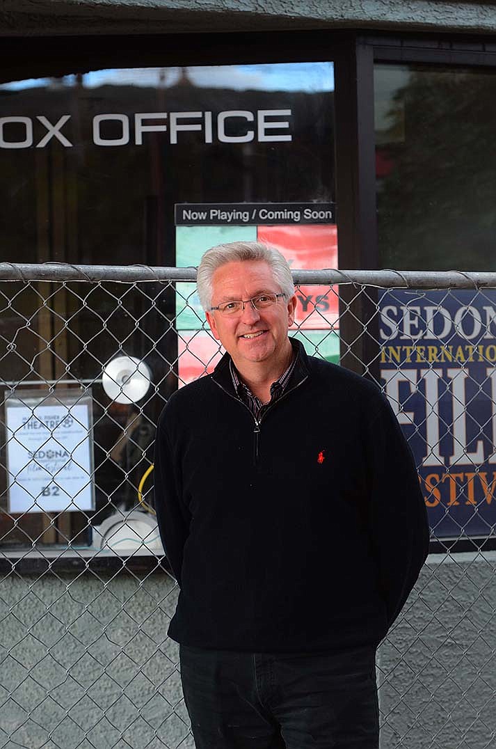 Patrick Schweiss, SIFF executive director, poses for a photo in front of the box office and construction site on Tuesday, Dec. 14, 2021. (Kudos/Vyto Starinskas)