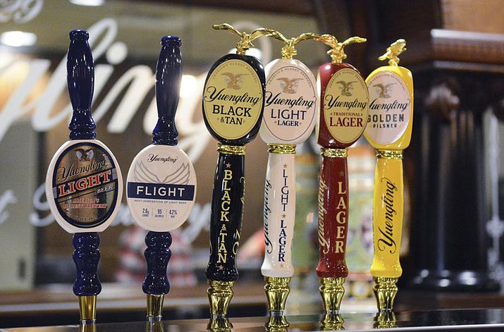 In this Feb. 21, 2020 photo, Yuengling's new upscale light beer, Flight, is seen on tap with Yuengling's other beers at D.G. Yuengling & Son's Mill Creek brewery in Pottsville, Pa. A trademark tiff between America’s oldest beer maker and its best-selling beer brand appears to be over before it really began. D.G. Yuengling & Son demanded its much larger rival, Anheuser-Busch, stop using a tagline for its forthcoming Bud Light Next zero-carb beer. Bud Light had been calling it the “next generation of beer.” Yuengling says that's too close to the trademarked slogan it uses for its Flight low-carb brew. (Lindsey Shuey/Republican-Herald via AP, File)