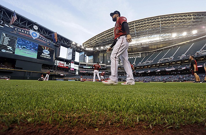 Arizona Diamondbacks' Steven Souza Jr. walks on new synthetic grass at Chase Field before a spring training baseball game against the Chicago White Sox, March 25, 2019, in Phoenix, Ariz. The Diamondbacks ripped out the grass at the field ahead of the 2019 season, replacing it with the artificial turf. The team says they've saved about 16 million gallons of water because of it. (AP Photo/Elaine Thompson, File)