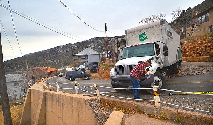 Jerome Police Chief Allen Muma, the Jerome Fire Department and Public Works Department work to free a truck stuck on State Route 89A on Tuesday, Dec. 22, 2021. (Verde Independent/Vyto Starinskas)