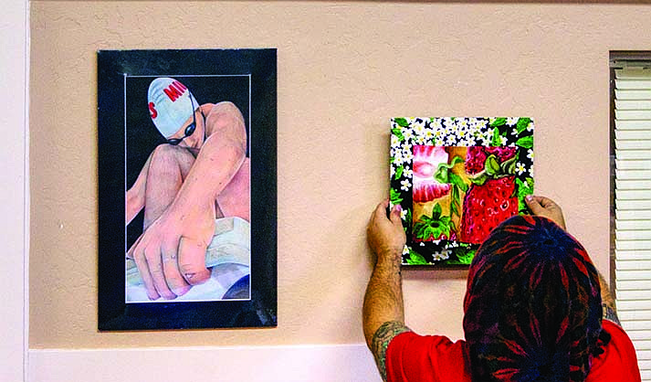 Jason Teague hangs strawberries beside a swimmer with forced perspective. (Courtesy/FOCML)