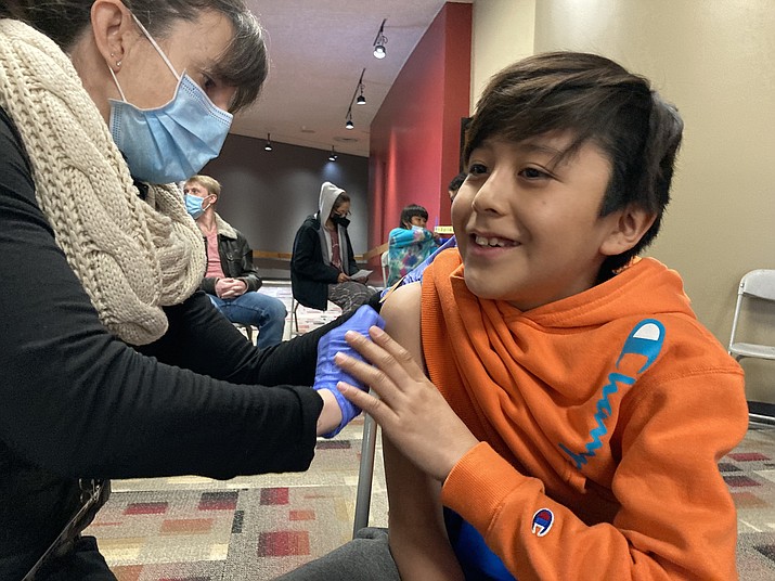 Koda Frank, 10, receives his first shot of the COVID-19 vaccine Dec. 18 from Coconino County nurse Megan Hinkley at a mobile vaccine pop-up event  in Page, Arizona. The event was sponsored by the city of Page, Coconino County Health and Human Services and partners Canyonlands Healthcare. (Katherine Locke/NHO)