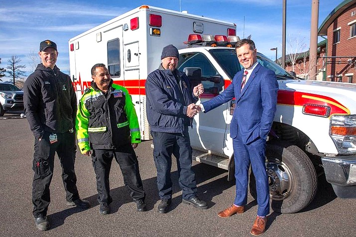 NAH Chief Operating Officer, Josh Tinkle (right) and Guardian Medical Transport Director Vince Martinez (left) hand over the keys to a new ambulance to Tusayan Fire Chief Greg Bush and Battalion Chief Matt Shaw. (Photo/Northern Arizona Healthcare)