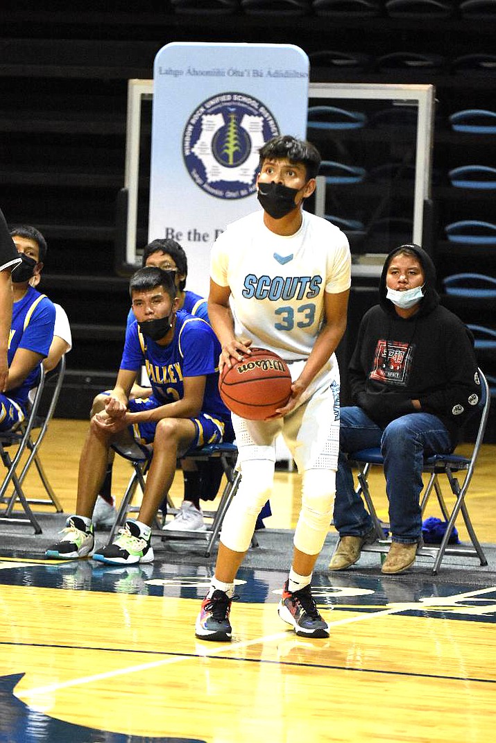 Isiah Begay pulls up for a baseline jumper against the Sanders High School Pirates. Scouts won the game led by Begay with 27 points. (Photos/Bernie Dotson)