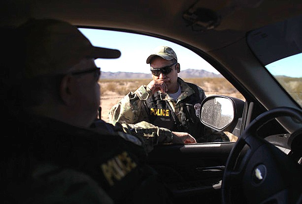 A Shadow Wolf stands next to a vehicle during a patrol. (Photo/ICE, U.S. Immigration and Custom Service)