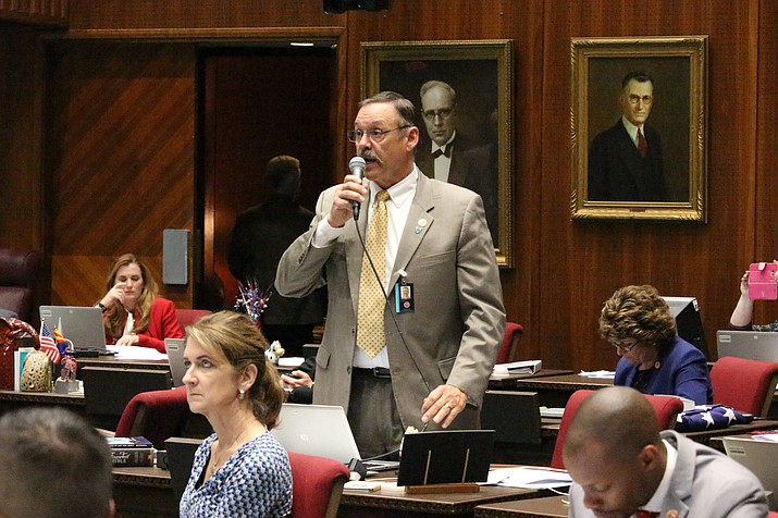 Republican Rep. Mark Finchem speaks May 2, 2018, at the Capitol in Phoenix. In the year since the Jan. 6 riot, Donald Trump-aligned Republicans have worked to clear the path for next time. In battleground states and beyond, Republicans are systematically taking hold of the once overlooked machinery of elections, weakening or replacing the checks in place to prevent partisan meddling with results. (Bob Christie/AP, File)