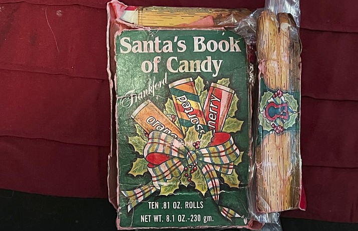 This Ryan Wasson family photograph shows a box of "Santa's Book of Candy," which contains 10 rolls of candy, on Dec. 18, 2021, in Ossipee, N.H. Two New Hampshire brothers have gotten their holiday regifting skills down to an art, and have been passing the same hard candy treats back and forth for over 30 years. (Ryan Wasson family photograph via AP)
