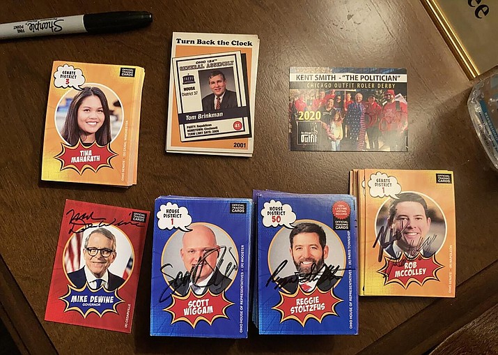 Trading cards that Ohio House legislative aide Adam Headlee had signed by all 99 state representatives are photographed at his office in the Riffe Center in Columbus, Ohio, on Friday, Dec. 17, 2021. Headlee said the good humor with which both Republicans and Democrats greeted his project sends “a subtle message of unity” at a politically divided time. (Julie Carr Smyth/AP)