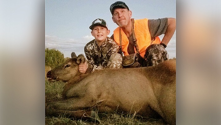 Jace, left, and his father, Jimmy Martin, pose with the female elk that Jace killed in his first hunt in Arizona with his guide and grandfather, Miner outdoors writer Don Martin. (File photo by Don Martin/For the Miner)
