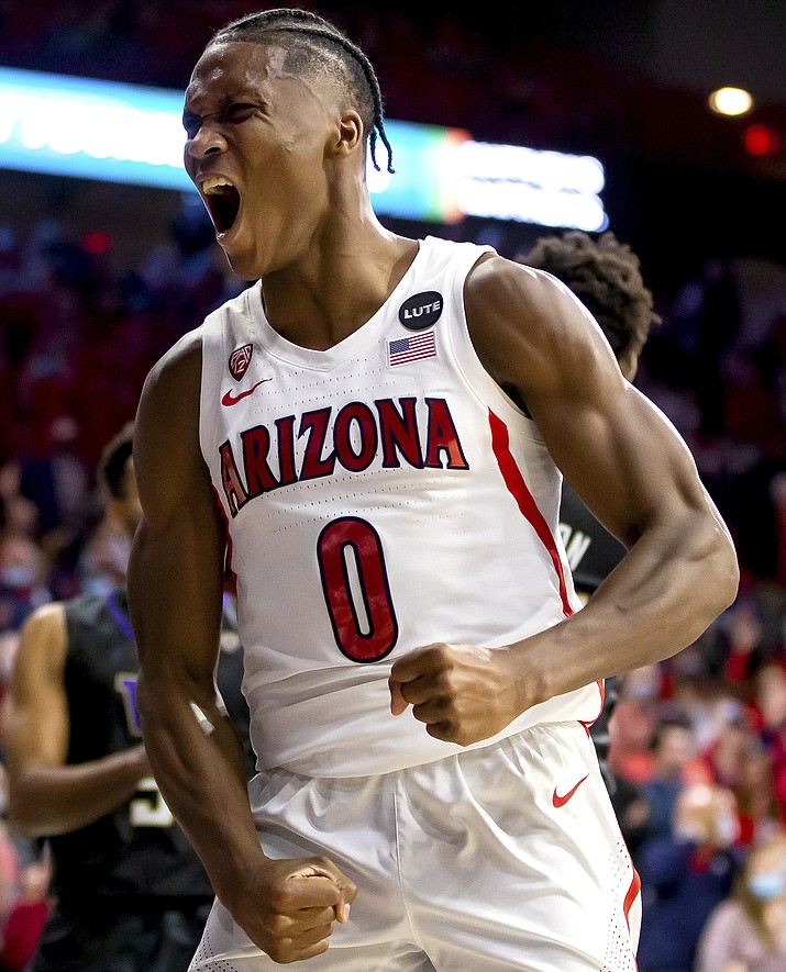 Arizona guard Bennedict Mathurin (0) reacts after getting an and-one during the second half of a game against Washington in Tucson, Ariz., Monday, Jan. 3, 2022. (Rebecca Sasnett/Arizona Daily Star via AP)