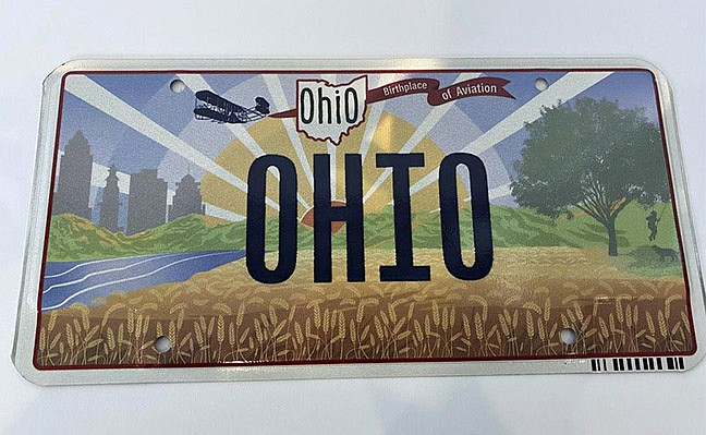 Ohio Gov. Mike DeWine on Thursday, Oct. 21, 2021, unveiled the new "Sunrise in Ohio" license plate in Columbus, Ohio. A backwards image of the Wright Flyer that appeared on the initial version of Ohio’s new license plate was added to the design early and never changed or questioned throughout the approval process, according to public records obtained by The Associated Press. The error was fixed only after the public unveiling in October drew attention to it. (Jessie Balmert/The Cincinnati Enquirer via AP, File)