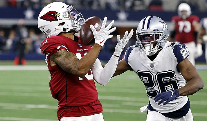Arizona Cardinals wide receiver Christian Kirk (13) catches a pass for a first down as Dallas Cowboys cornerback Jourdan Lewis (26) defends during the second half of an NFL football game Sunday, Jan. 2, 2022, in Arlington, Texas. (AP Photo/Michael Ainsworth)