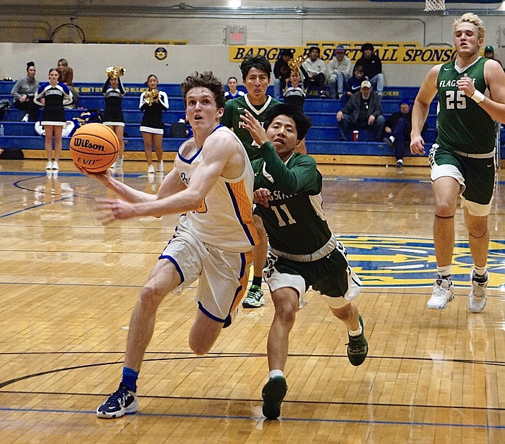 Prescott guard Jason Parent (15) drives to the basket through a defender during a game against Flagstaff on Friday, Jan. 7, 2022, at Prescott’s Dome Gym. (Aaron Valdez/Courier)