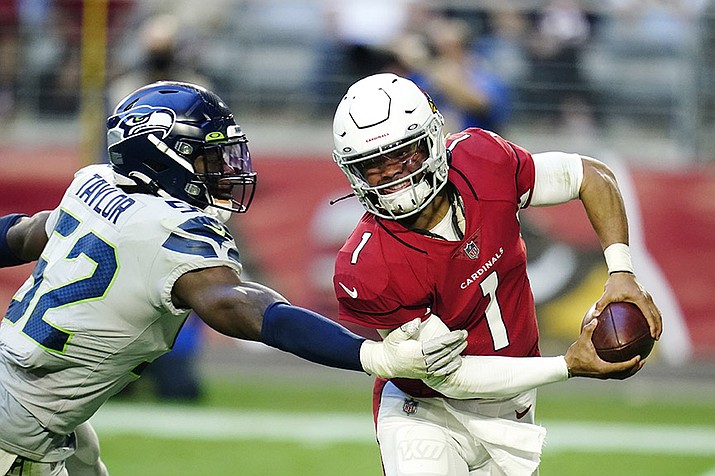 Seattle Seahawks defensive end Darrell Taylor (52) wraps up Arizona Cardinals quarterback Kyler Murray (1) for a sack during the second half of an NFL football game Sunday, Jan. 9, 2022, in Glendale, Ariz. (Darryl Webb/AP)
