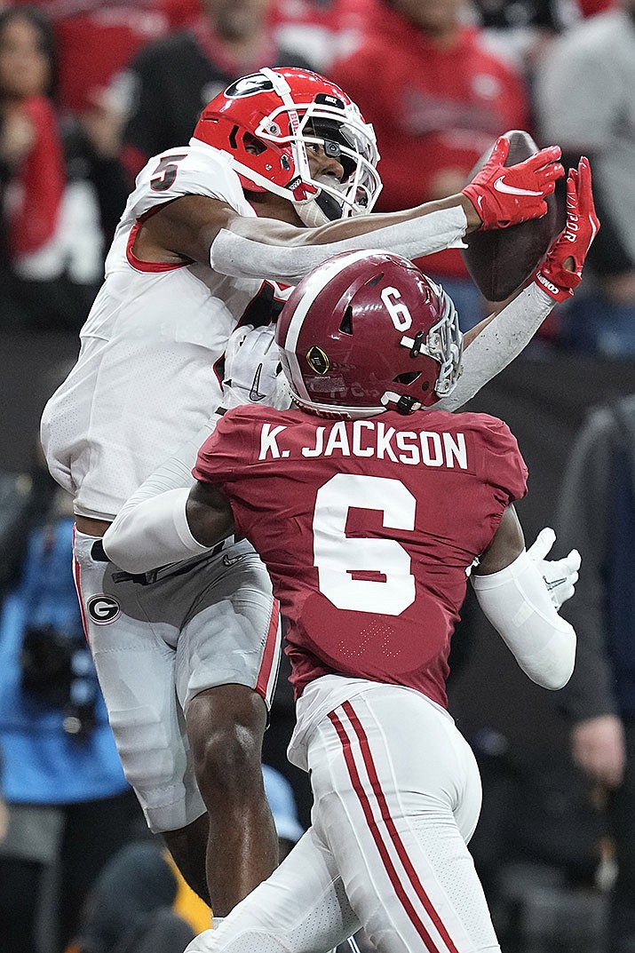 Georgia's Adonai Mitchel catches a touchdown pass over Alabama's Khyree Jackson during the second half of the College Football Playoff championship football game Monday, Jan. 10, 2022, in Indianapolis. (Darron Cummings/AP)