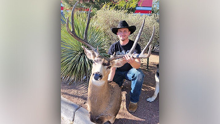 Jeremy Osborn of Phoenix poses with the mount of a buck he took in the Kaibab peninsula, which was mounted by Kingman taxidermist Amber Kirby. (Photo by Don Martin/For the Miner)