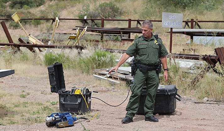 Border Patrol Agent Kevin Hecht demonstrates a robot at the CBP training area, which includes a tunnel for agents to get an idea of the conditions in which they may need to deploy a robot. (Photo by Kasey Brammell/Cronkite News)