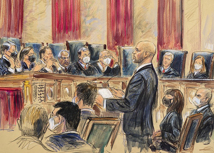 This artist sketch depicts lawyer Scott Keller standing to argue on behalf of more than two dozen business groups seeking an immediate order from the Supreme Court to halt a Biden administration order to impose a vaccine-or-testing requirement on the nation's large employers during the COVID-19 pandemic, at the Supreme Court in Washington, Jan. 7, 2022. The Supreme Court has stopped the Biden administration from enforcing a requirement that employees at large businesses be vaccinated against COVID-19 or undergo weekly testing and wear a mask on the job. The court's order Thursday during a spike in coronavirus cases deals a blow to the administration's efforts to boost the vaccination rate among Americans. (Dana Verkouteren via AP, File)