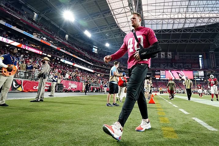 An injured Arizona Cardinals defensive end J.J. Watt walks off the field after an game against the Carolina Panthers on Nov. 14, 2021, in Glendale, Ariz. The three-time NFL Defensive Player of the Year is trying to complete a miraculous comeback from a serious shoulder injury in an effort to help the Cardinals' defense when they travel to face the Los Angeles Rams on Monday night in the wild card round. (Darryl Webb/AP, File)