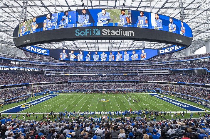 This is a general overall interior view of SoFi Stadium as the Los Angeles Rams takes on the Tampa Bay Buccaneers in a game Sunday, Sept. 26, 2021, in Inglewood, Calif. A late-season surge in COVID-19 cases had the NFL in 2021 looking a lot like 2020, when the coronavirus led to significant disruptions, postponements and changing protocols. The emerging omicron variant figures to play a role all the way through the playoffs, including the Super Bowl in Los Angeles, where California has always been aggressive with policies to combat the spread of the virus. (Kyusung Gong/AP, File)