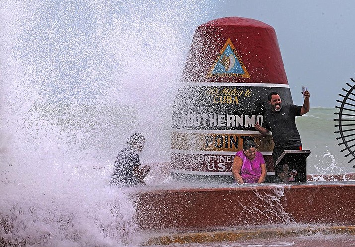 Key West resident Pedro Lara takes a selfie in front of the Southernmost Point as waves from Hurricane Irma crash over the wall on Sept. 9, 2017. The 20-ton concrete buoy, which marks the Southernmost Point of the U.S. and 90 miles to Cuba, is one of Key West’s famous landmarks. Tourists flock to the marker every day to take photos, snap selfies, buy a souvenir or two. (Miami Herald, Charles Trainor Jr. via AP, File)