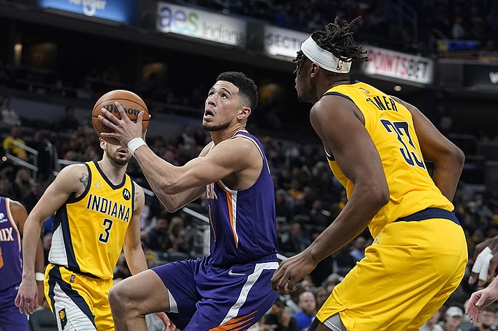 Phoenix Suns' Devin Booker goes to the basket against Indiana Pacers' Myles Turner (33) during the second half of an NBA basketball game, Friday, Jan. 14, 2022, in Indianapolis. (Darron Cummings/AP)