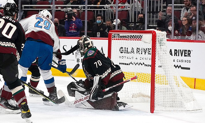Colorado Avalanche's Nathan MacKinnon (29) scores against the Arizona Coyotes' goalkeeper Karel Vehmelka (70) during the first period of an NHL hockey game Saturday, Jan. 15, 2022, in Glendale, Ariz. (Darryl Webb/AP)