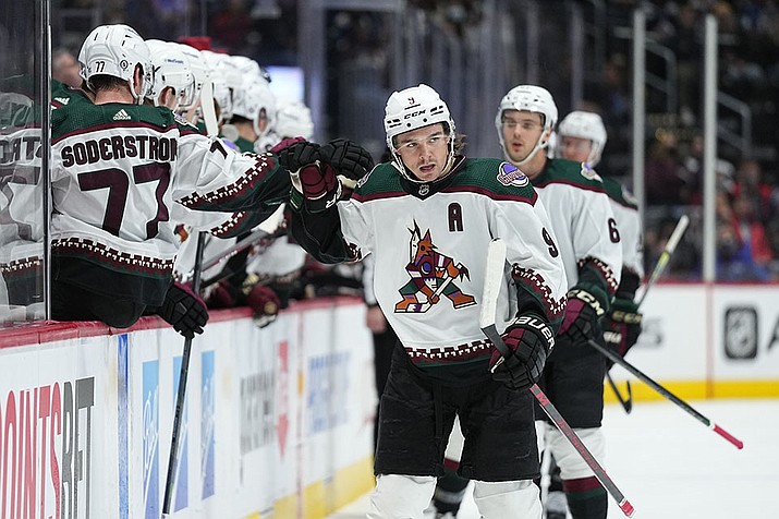 Arizona Coyotes right wing Clayton Keller celebrates a goal against the Colorado Avalanche with teammates on the bench during the first period of an NHL hockey game Friday, Jan. 14, 2022, in Denver. (Jack Dempsey/AP)