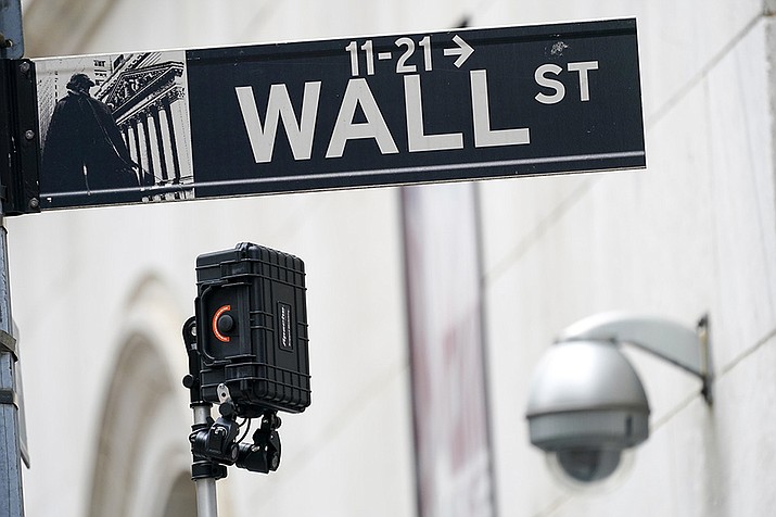 A Wall Street sign is seen next to surveillance equipment outside the New York Stock Exchange, Oct. 5, 2021, in New York A late-afternoon recovery in technology stocks helped erase most of the market’s losses Friday, but it wasn’t enough to keep major indexes from logging their second losing week in a row. (Mary Altaffer, AP file)