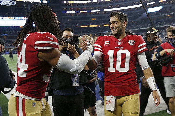 San Francisco 49ers middle linebacker Fred Warner, left, celebrates with quarterback Jimmy Garoppolo (10) after the 49ers defeated the Dallas Cowboys in an NFL wild-card playoff football game in Arlington, Texas, Sunday, Jan. 16, 2022. (Roger Steinman/AP)