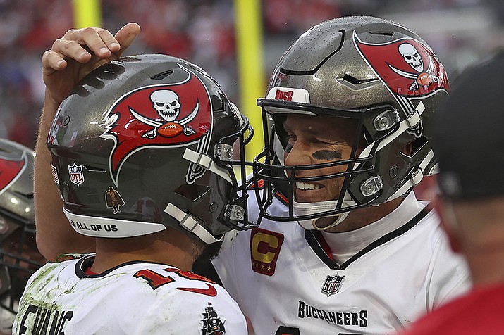 Tampa Bay Buccaneers quarterback Tom Brady, right, celebrates with wide receiver Mike Evans after Evans caught a touchdown pass against the Philadelphia Eagles during the second half of an NFL wild-card football game Sunday, Jan. 16, 2022, in Tampa, Fla. (Mark LoMoglio/AP)