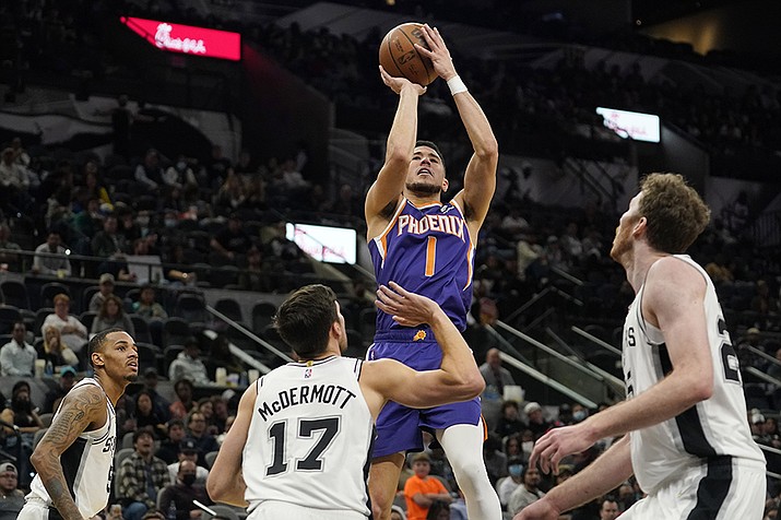 Phoenix Suns guard Devin Booker (1) shoots against the San Antonio Spurs during the second half of an NBA basketball game, Monday, Jan. 17, 2022, in San Antonio. (Eric Gay/AP)