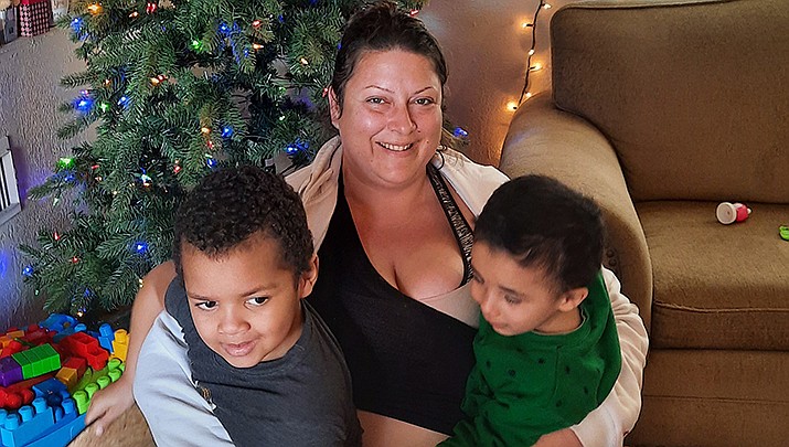 Local Army veteran Joni Reiss is pictured with her two boys in their new Kingman home next to a Christmas tree donated by Home Depot. (Courtesy photo)