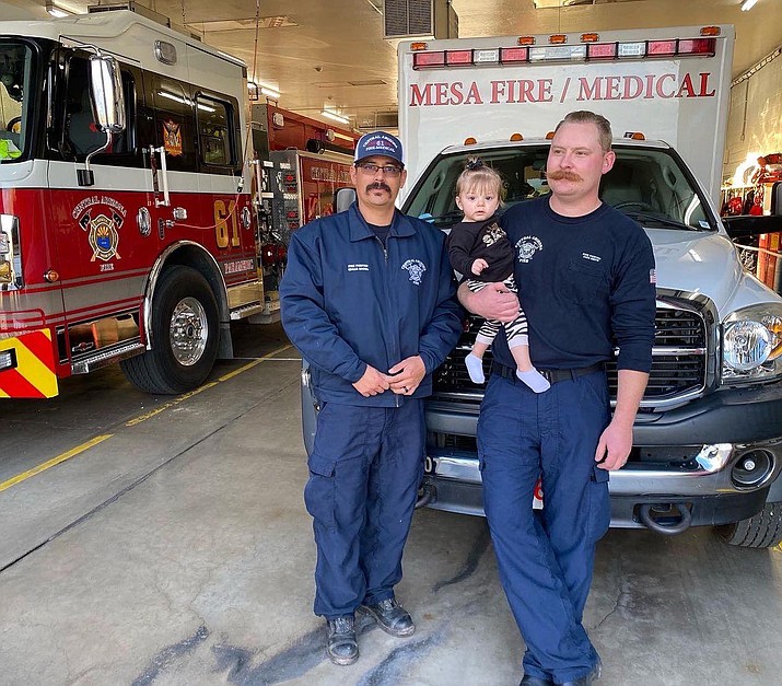 Central Arizona Fire and Medical Authority firefighters Rocha, left, and Smith visited baby Lily on her first birthday on Dec. 22, 2021. Baby Lily was the 8-month-old in Chino Valley who was in cardiac arrest and respiratory distress before Rocha and Smith responded to the scene and transported her to the hospital on Aug. 20, 2021. (CAFMA/Courtesy)