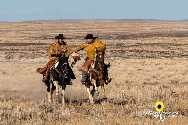 Clear Creek Cowboys hand off mail bags during a previous ride. Riders with the group will make a ride from Winslow to Holbrook Jan. 29 to deliver mail by horseback. Mail can be dropped off at the Winslow Post Office for Pony Express delivery by Jan. 28. (Photo courtesy of Clear Creek Cowboys)