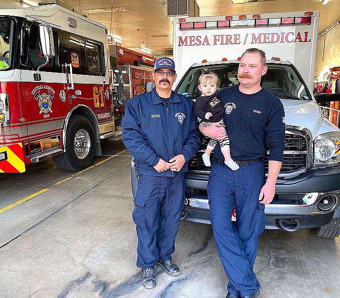 Central Arizona Fire and Medical Authority firefighters Rocha, left, and Smith visited baby Lily on her first birthday on Dec. 22, 2021. (CAFMA/Courtesy)