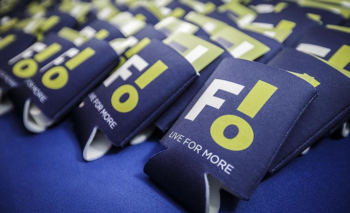 Beverage sleeves with the city of Florence's new logo sit out for guests to take home following a reveal at the Shoals Community Theatre, Tuesday, Jan. 25, 2022, in Florence, Ala. Some residents think the city's new logo might be sending the wrong message. (Dan Busey/The TimesDaily via AP)