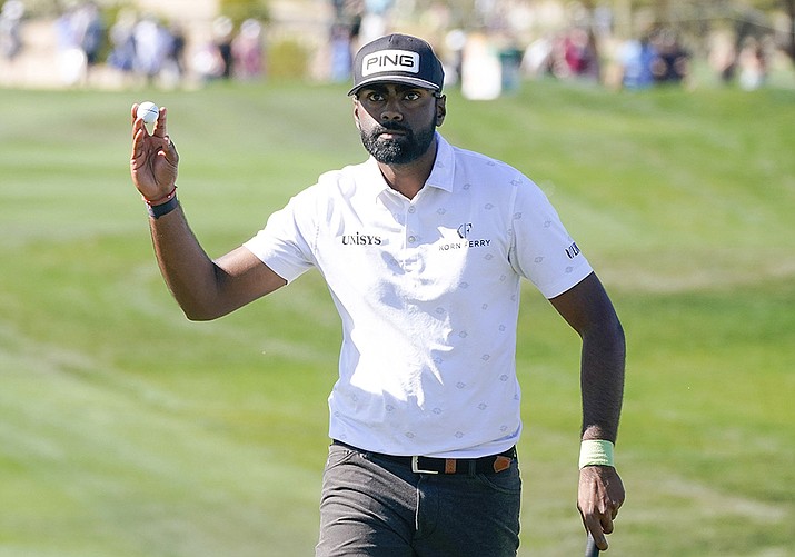 Sahith Theegala acknowledges the gallery on the ninth hole after making a birdie during the third round of the Phoenix Open golf tournament Saturday, Feb. 12, 2022, in Scottsdale.(Darryl Webb/AP)