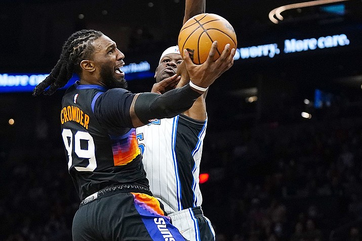 Phoenix Suns forward Jae Crowder, left, drives past Orlando Magic center Mo Bamba to score during the first half of an NBA basketball game Saturday, Feb. 12, 2022, in Phoenix. (Ross D. Franklin/AP)
