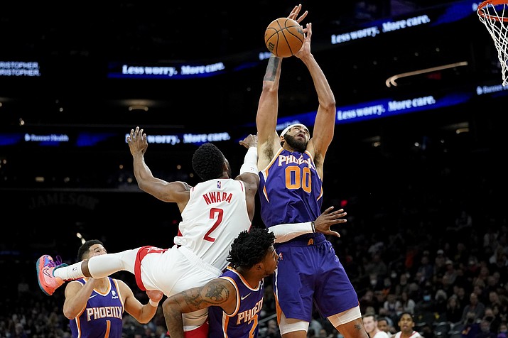 Phoenix Suns center JaVale McGee (00) rebounds over Houston Rockets forward David Nwaba (2) during the first half of a game Wednesday, Feb. 16, 2022, in Phoenix. (Matt York/AP)